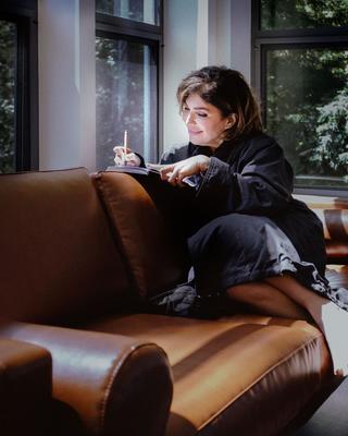 Woman sitting in a Canyon Ranch Woodside treehouse journaling.