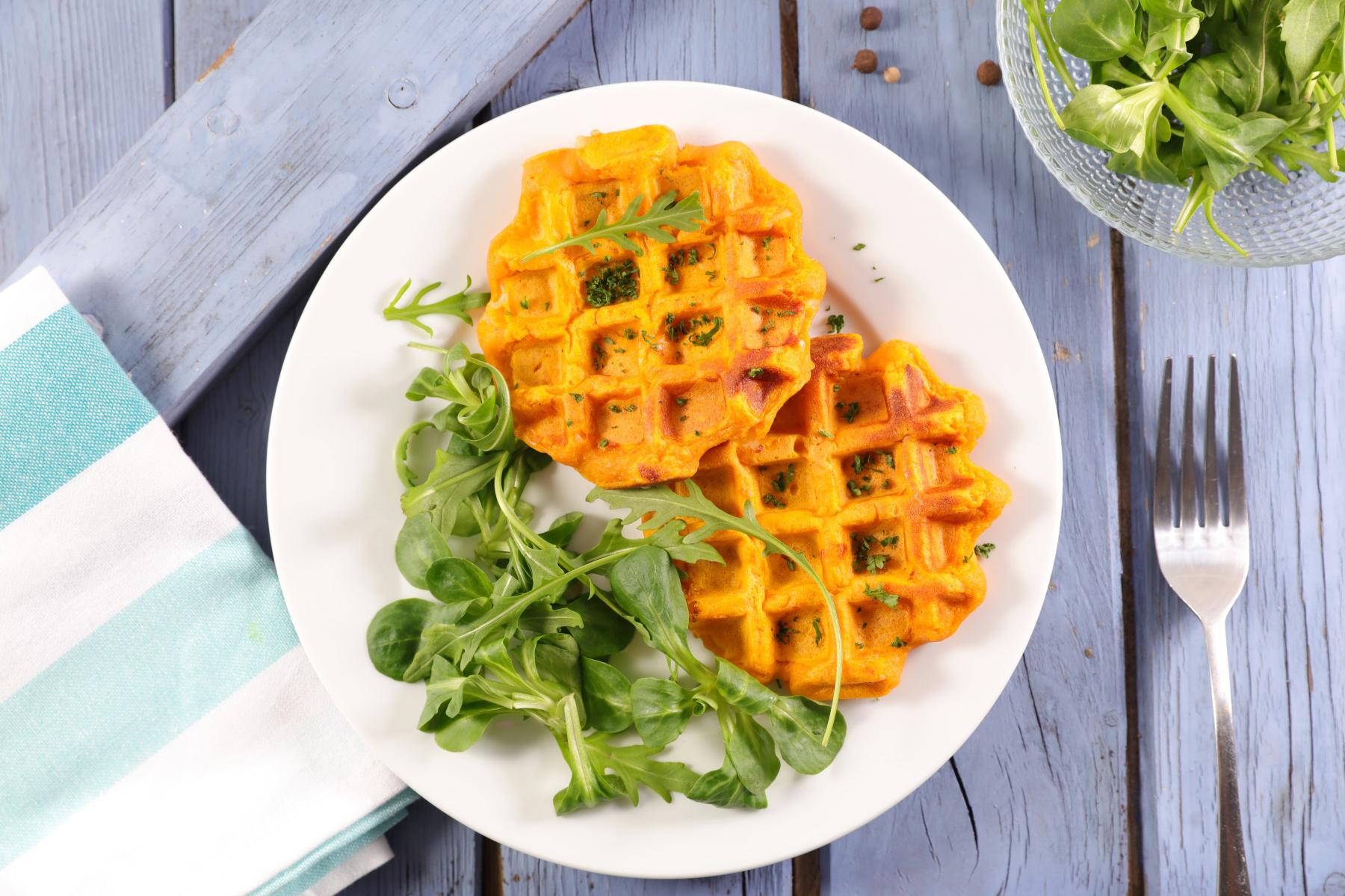 Overhead view of sweet potato waffles on a plate.