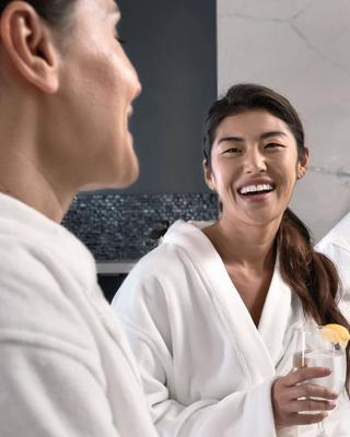 Women in robes smiling and laughing