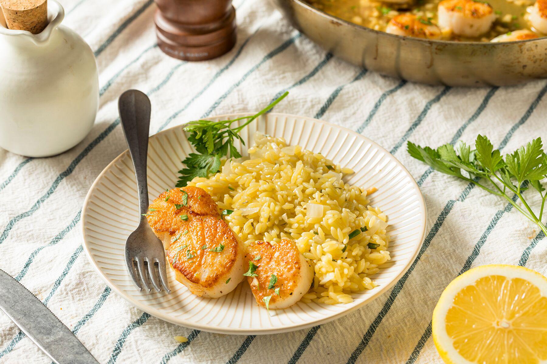 A colorful plate of Seared Scallops with Autumn Squash Risotto