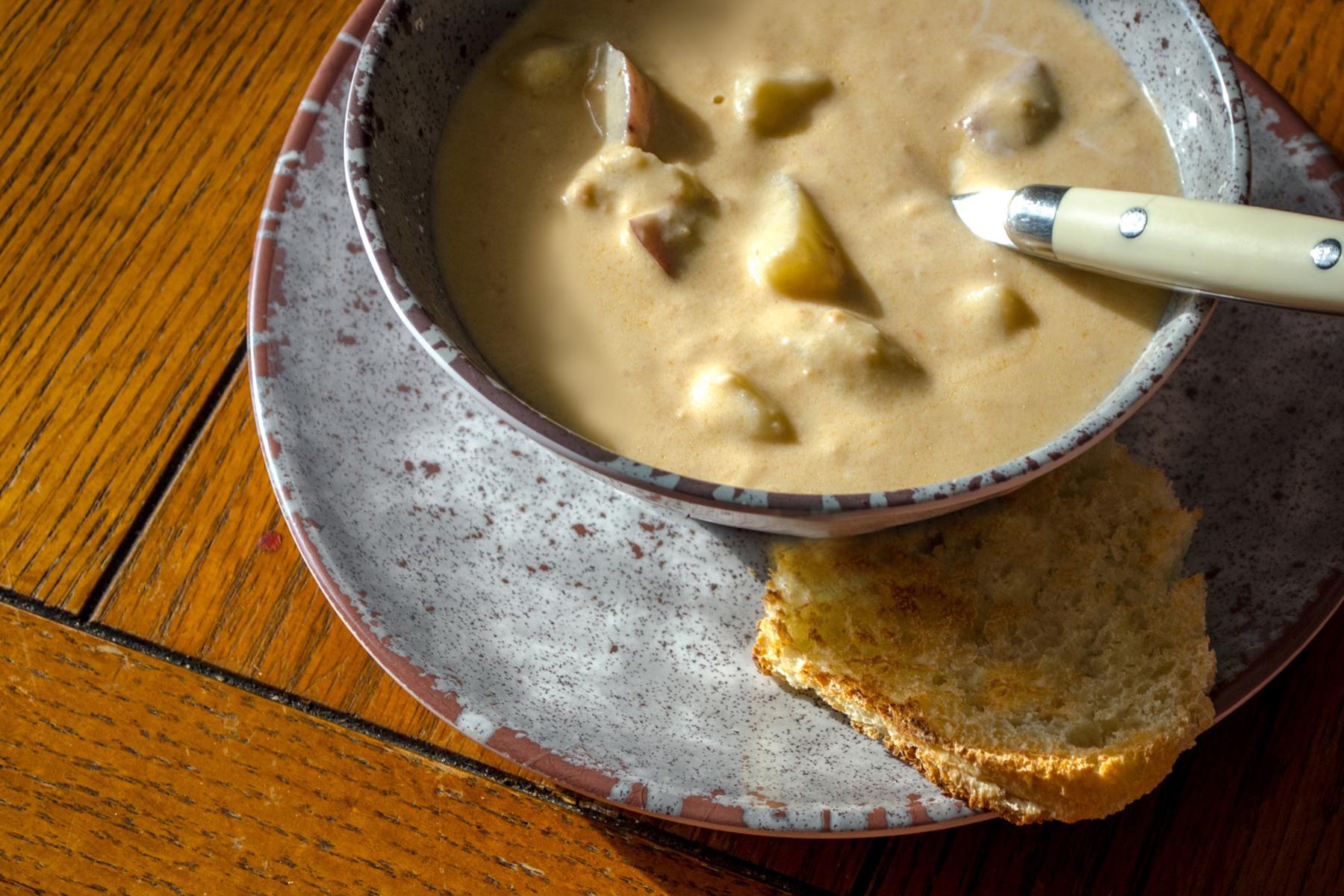 Overhead view of a bowl of potato soup.