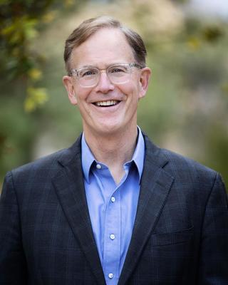 A headshot of Dr. Stephen Brewer